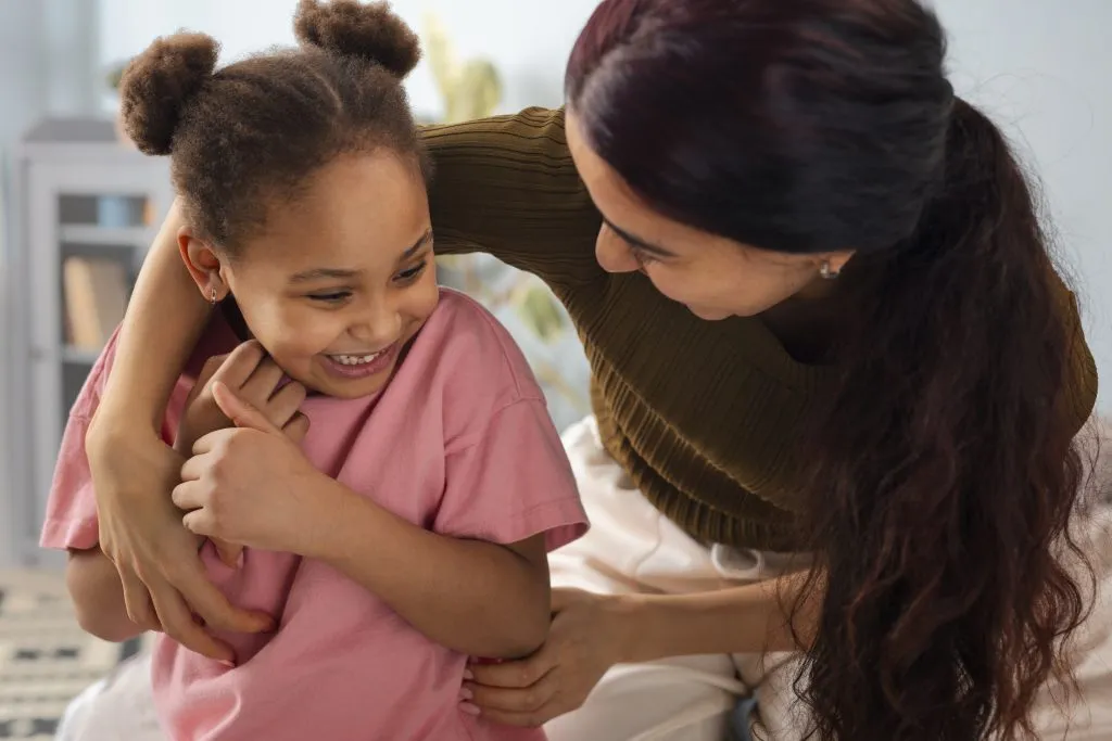 An image of a mother sharing a tender, affectionate moment with her daughter.