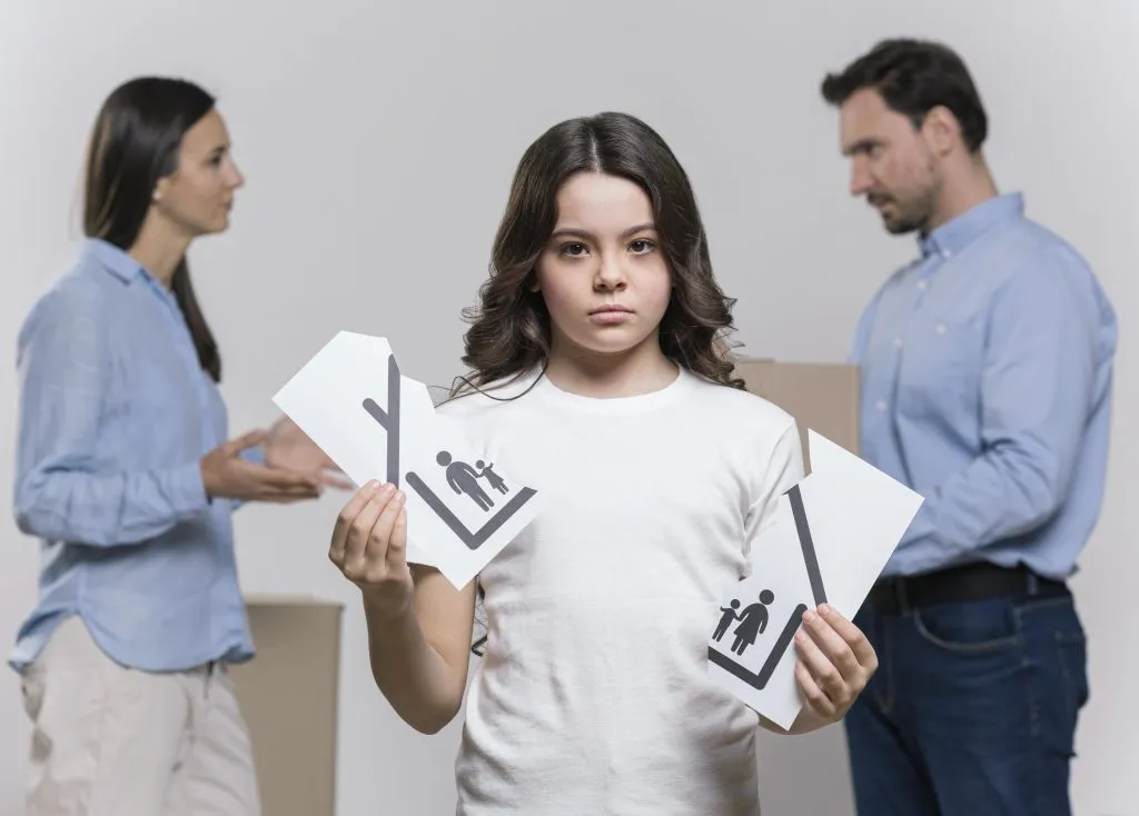 An image of a sad young girl in the foreground, with her parents arguing in the background.