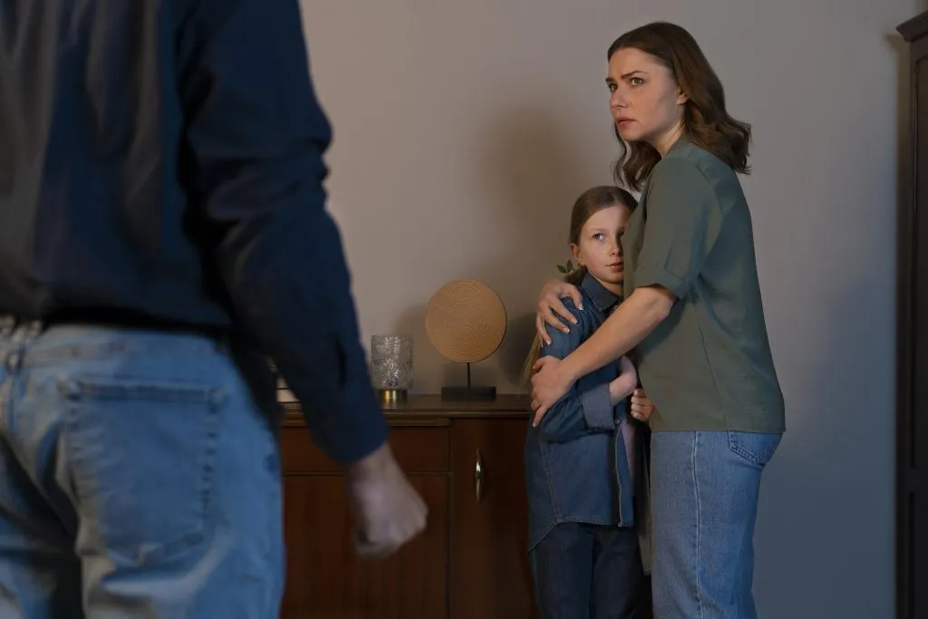 An image of a young child looking distressed, witnessing their parents constantly arguing.
